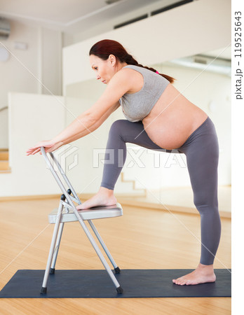 Pregnant woman is engaged in yoga. Yoga exercises for legs, buttocks and thighs for a lift Pregnant woman is engaged in yoga. Yoga exercises for legs, buttocks and thighs for a lift 119525643