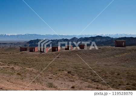 Isolated desert lodging: Modern wooden structures on hillside with panoramic views 119528070
