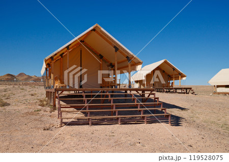 Luxury desert glamping. Upscale tent lodge with wooden deck Luxury desert glamping. Upscale tent lodge with wooden deck 119528075