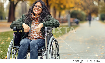 Joyful autumn day: smiling disabled woman in a wheelchair enjoys park outing Joyful autumn day: smiling disabled woman in a wheelchair enjoys park outing 119531628