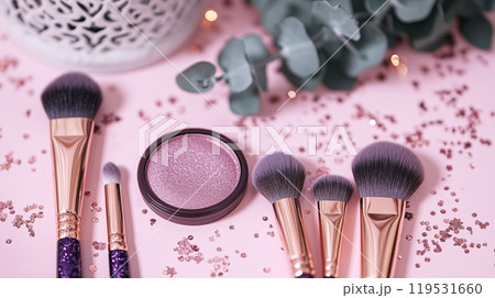 Elegant makeup brushes and sparkling cosmetics on a pink background 119531660