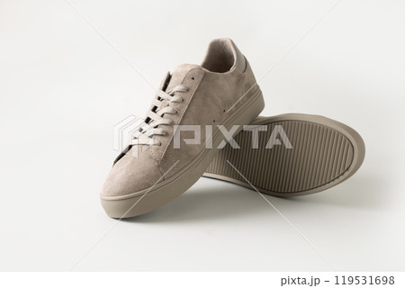 Leather nubuck gray men's gumshoes on light gray background. Men's sports casual shoes. Fashionable sneakers. Close up. 119531698
