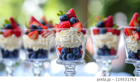 Delicious berry parfaits with whipped cream in elegant glasses 119531763