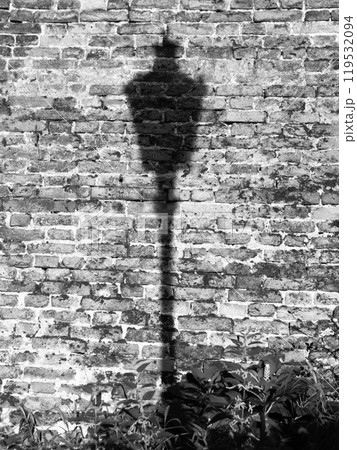 Lamp post shadow on the brick wall. Old Town of Prague, Czech Republic. Black and white image. 119532094