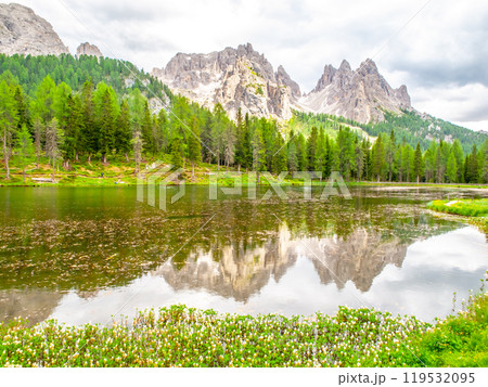 Mountain summits reflected in water of Antorno Lake, Dolomites, Italy. 119532095