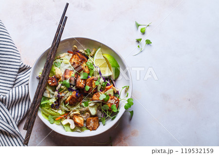 Crispy tofu salad with cashews and sprouts. 119532159
