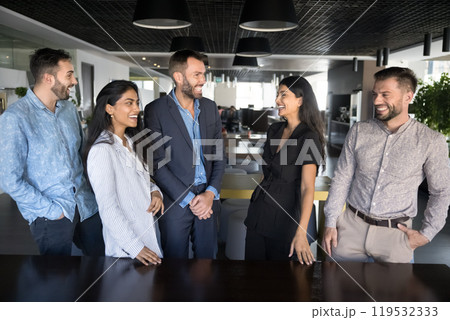 Cheerful diverse young business colleagues enjoying successful teamwork 119532333