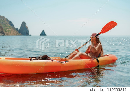 Kayak sea woman. Happy attractive woman with long hair in red swimsuit, swimming on kayak. Summer holiday vacation and travel concept. Kayak sea woman. Happy attractive woman with long hair in red swimsuit, swimming on kayak. Summer holiday vacation and travel concept. 119533811