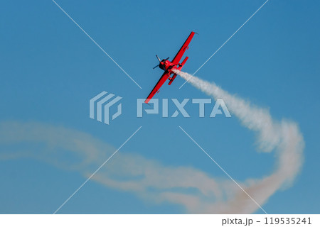 Stunt aerobatic plane performing stunts in air 119535241