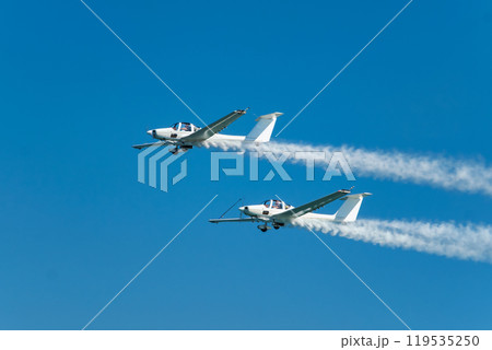 Stunt aerobatic plane performing stunts in air Stunt aerobatic plane performing stunts in air 119535250