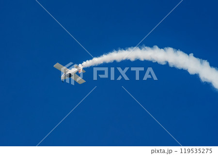Stunt aerobatic plane performing stunts in air 119535275