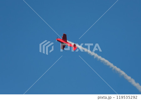 Stunt aerobatic plane performing stunts in air 119535292