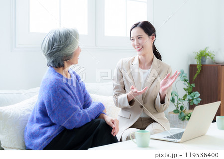 訪問営業の話を聞く中高年の女性 訪問営業の話を聞く中高年の女性 119536400