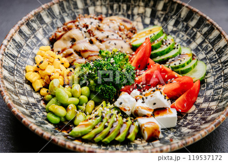 Colorful Buddha bowl with fresh vegetables, quinoa, and avocado, healthy eating and wellness lovers 119537172