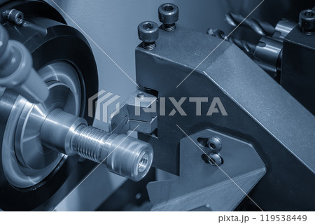 Close up scene the CNC lathe machine swiss type slot cutting at the end of brass pipe coupling parts in the light blue scene. 119538449