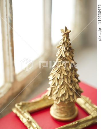 レトロな窓辺に置かれた古い洋書とクリスマスツリー レトロな窓辺に置かれた古い洋書とクリスマスツリー 119538476