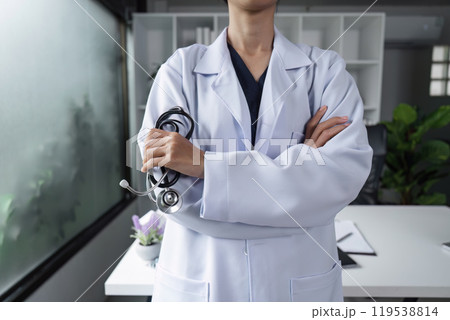 Confident Female Doctor in White Coat with Stethoscope in Modern Medical Office Setting 119538814