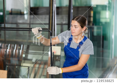 Female foreman inspecting plate glass cut to size Female foreman inspecting plate glass cut to size 119538825