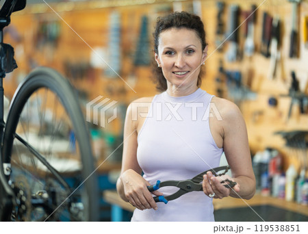 Adult woman posing with bicycle tool 119538851