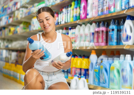 Young woman choosing detergent in store 119539131