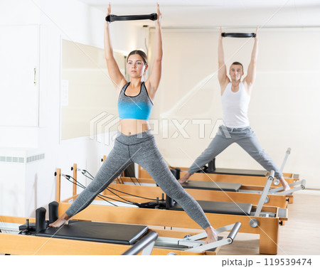 Girl restores her health with the help of gymnastic ring during Pilates classes 119539474