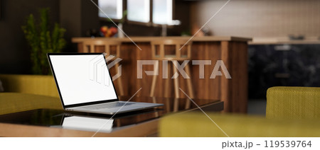 A close-up of a laptop on a coffee table in a contemporary living room. A close-up of a laptop on a coffee table in a contemporary living room. 119539764