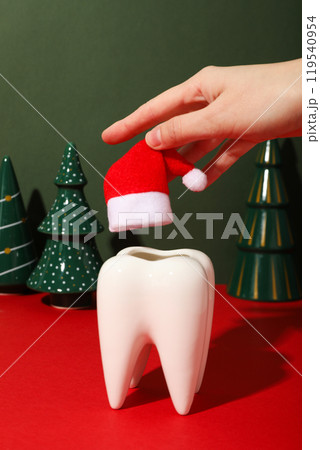 A tooth with a New Year's decoration around it. 119540954