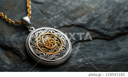 Ornate pendant on a dark stone background. Ornate pendant on a dark stone background. 119541183