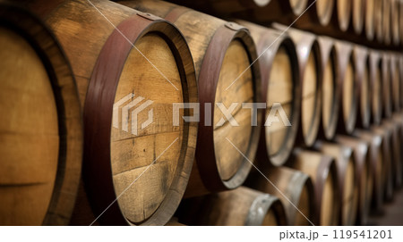 Row of wooden barrels in a dimly lit cellar. 119541201