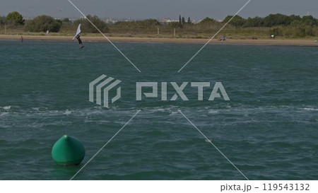 Green buoy floating as sailor falls in slow motion Green buoy floating as sailor falls in slow motion 119543132