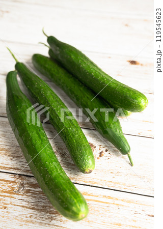 fresh cucumbers on a white wooden table 119545623