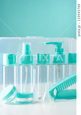 Clear containers for beauty products arranged on a white surface against a bright blue background Clear containers for beauty products arranged on a white surface against a bright blue background 119545789
