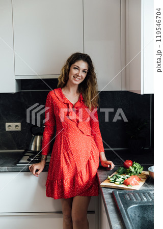 Photo of optimistic brunette hair young lady cook wear apron at kitchen 119546704