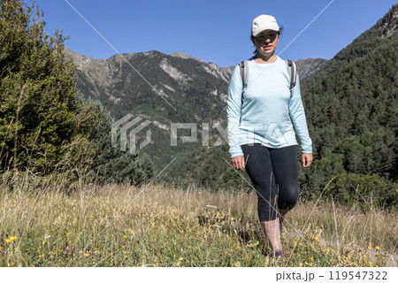 Young tourist woman walking on the Spanish Pyrenees mountain Young tourist woman walking on the Spanish Pyrenees mountain 119547322