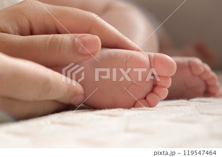 Tiny Babies Feet in Mother Hands. Close up of Small Bare Foot of Infant Sleeping on Soft Bed. Mom Stroking Cute Newborn Baby Toes. Childhood, Maternity, Health. Sleep Newborn Child Concept. Skin care Tiny Babies Feet in Mother Hands. Close up of Small Bare Foot of Infant Sleeping on Soft Bed. Mom Stroking Cute Newborn Baby Toes. Childhood, Maternity, Health. Sleep Newborn Child Concept. Skin care 119547464