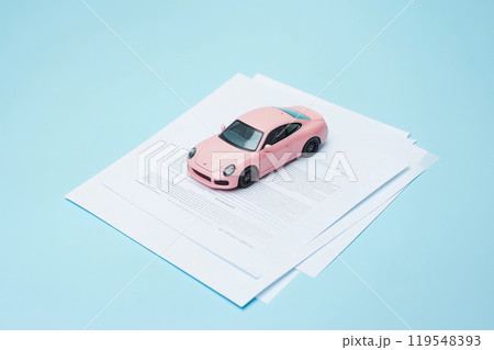 Pink Car Model on contract paper documents stack. Car insurance concept, car sale, Car loan application. Business Transaction for Buying, Selling, Leasing, Insuring a New or Used Vehicle. Choose auto 119548393