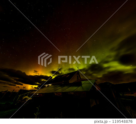 The Aurora Borealis, the northern lights, showing up above bungalow in County Donegal, Ireland The Aurora Borealis, the northern lights, showing up above bungalow in County Donegal, Ireland 119548876