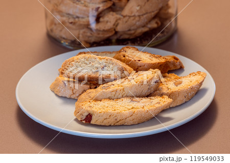 Almond cantucci cookies are arranged on a plate revealing their crisp texture and nutty flavor 119549033