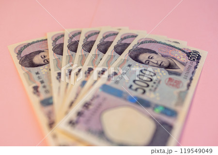 Fanned out 5000 yen bills on soft pink backdrop show detailed design, portrait of Japanese currency 119549049
