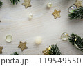 Festive background with Christmas branches and lights with copy space. White wooden table stars 119549550
