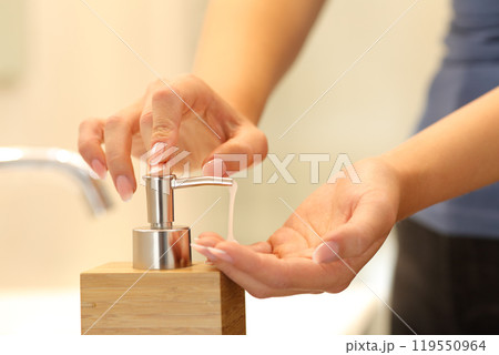 Woman hands applying soap ready to wash Woman hands applying soap ready to wash 119550964