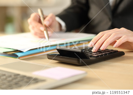 Bookkeepper hands calculating with calculator 119551347