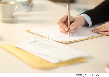 Business woman hand writing letter at the office Business woman hand writing letter at the office 119551358
