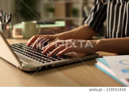 Entrepreneur hands working on laptop at night at home 119551428