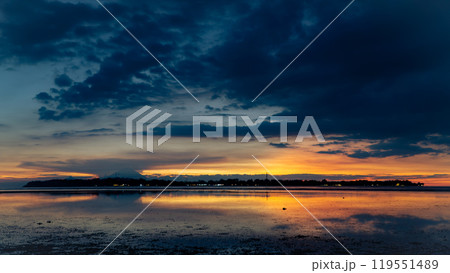 the sun is setting over a small island in the middle of the ocean 119551489