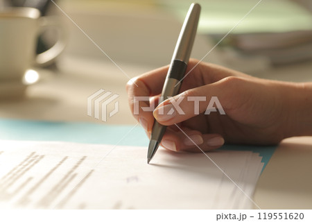 Profile of woman hand singing contract at office Profile of woman hand singing contract at office 119551620