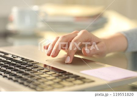 Woman hand with laptop using touchpad on a desk Woman hand with laptop using touchpad on a desk 119551820