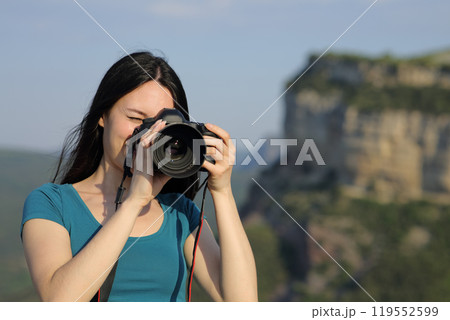 Asian tourist taking photos with dslr camera Asian tourist taking photos with dslr camera 119552599