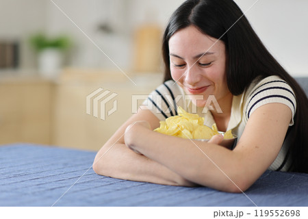 Gluttonous asian woman ready to eat potato chips 119552698