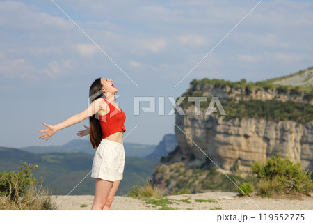 Mixed race woman screaming to the air in the pountain Mixed race woman screaming to the air in the pountain 119552775
